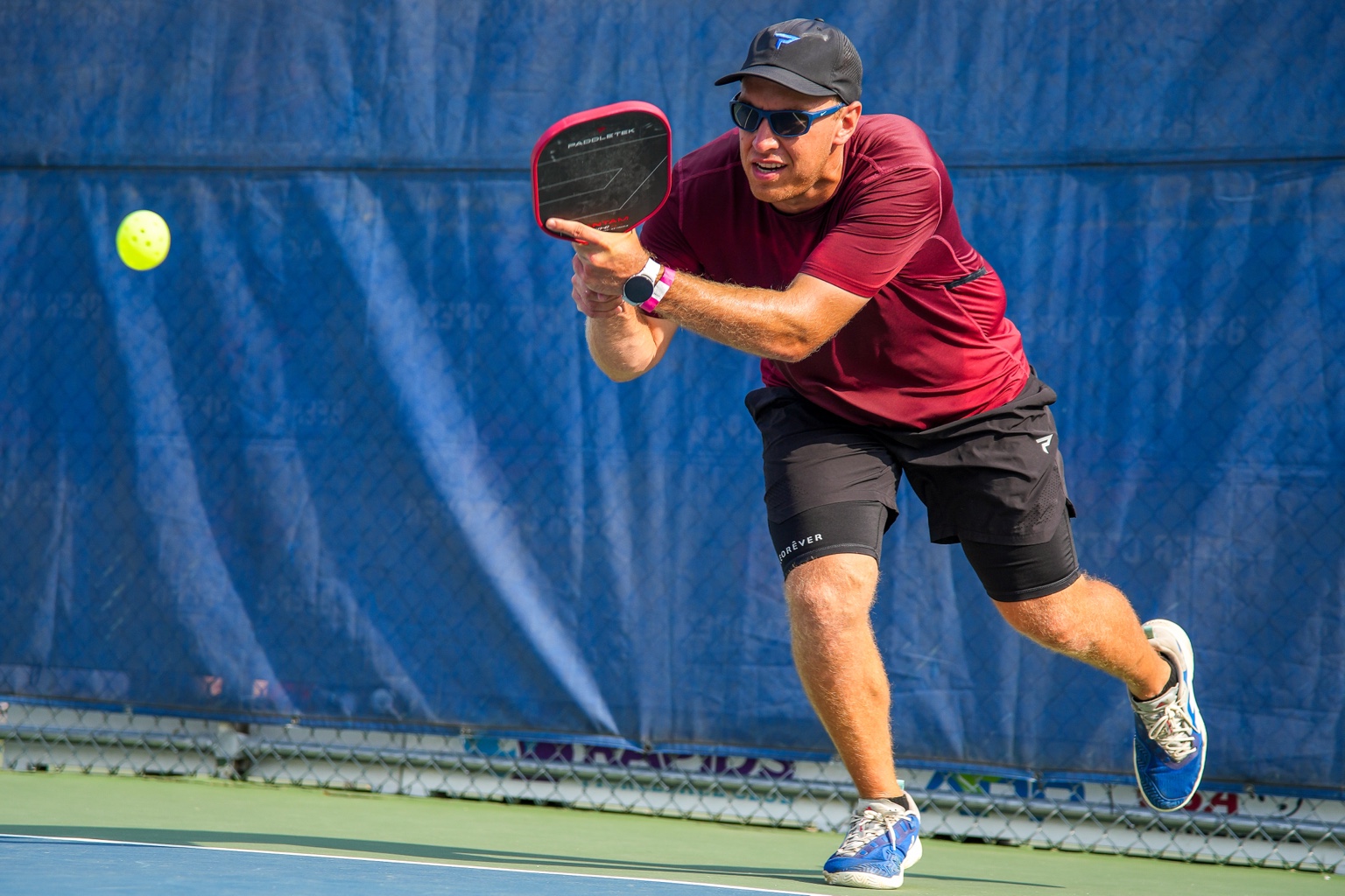 Jaron hitting a two-handed pickleball shot